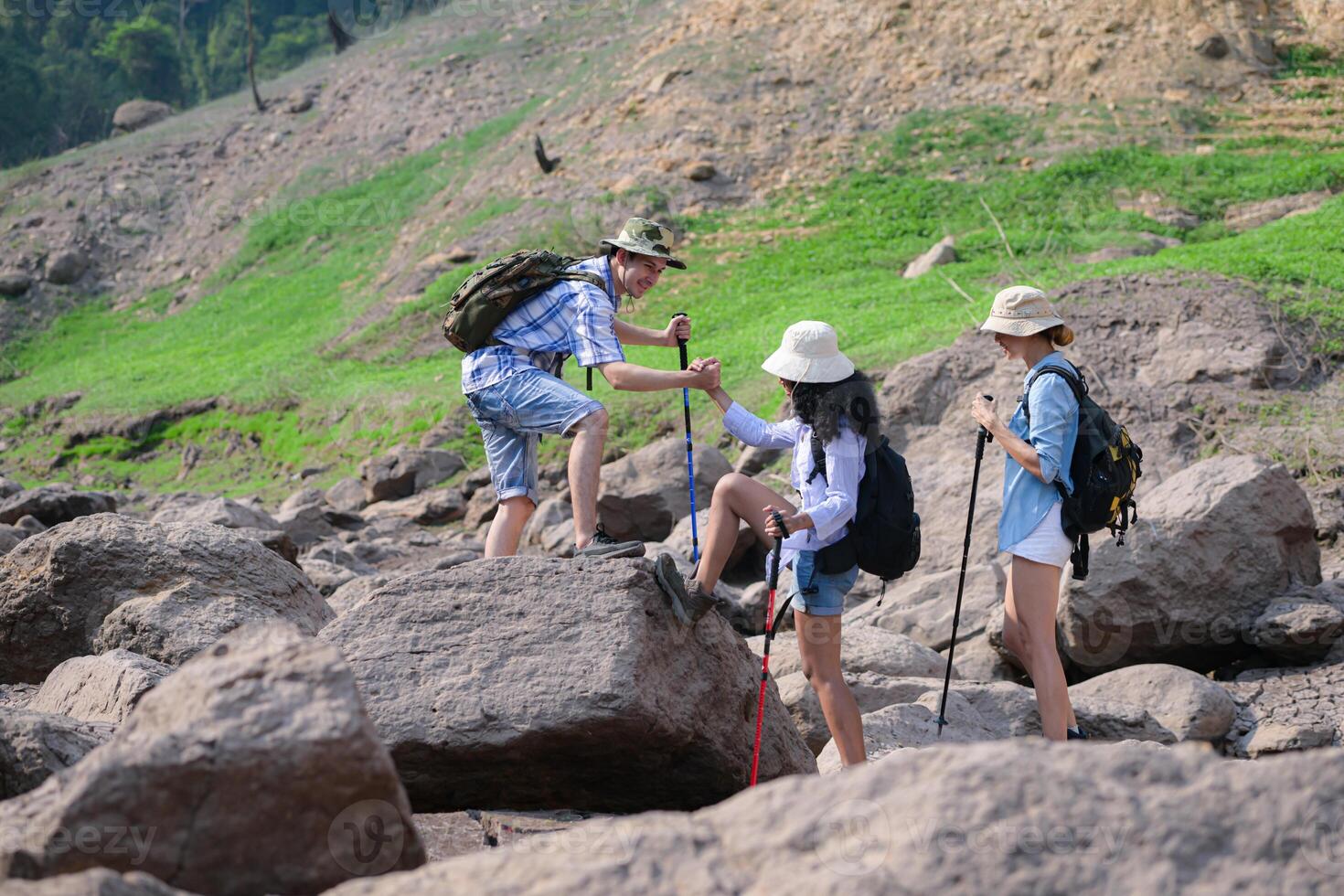 A group of friends going hiking in the streams of the tropical forest area. photo
