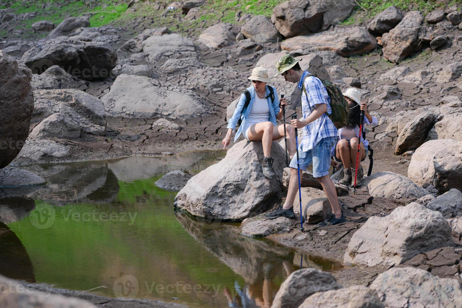 A group of friends going hiking in the streams of the tropical forest area. photo