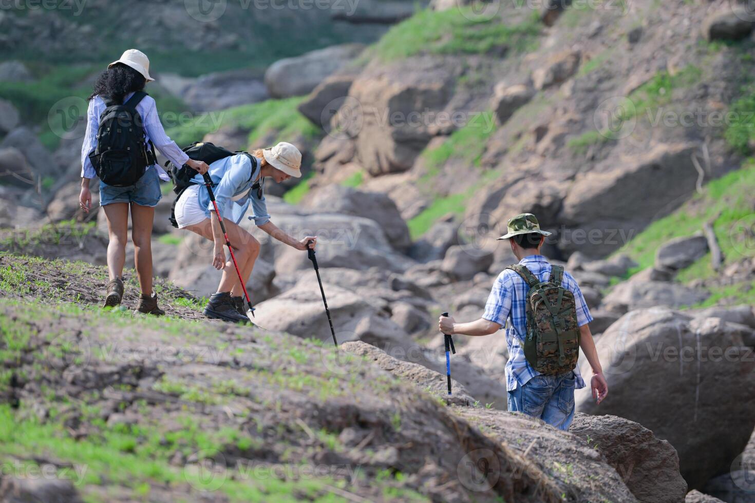A group of friends going hiking in the streams of the tropical forest area. photo