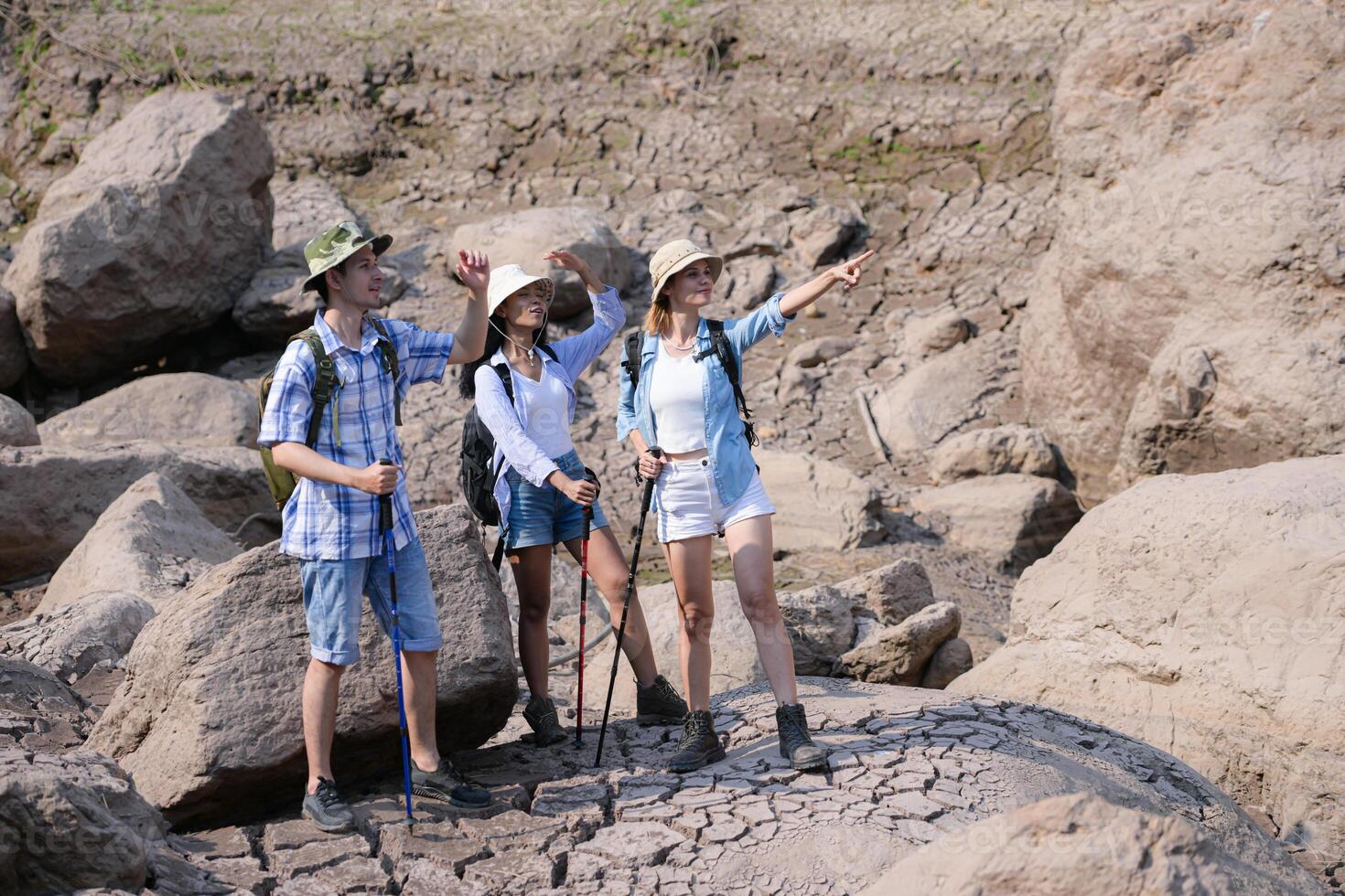 A group of friends going hiking in the streams of the tropical forest area. photo