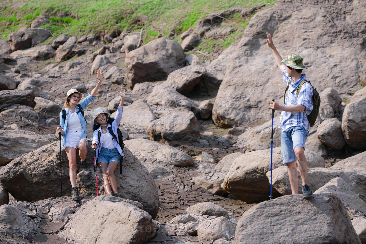 A group of friends going hiking in the streams of the tropical forest area. photo