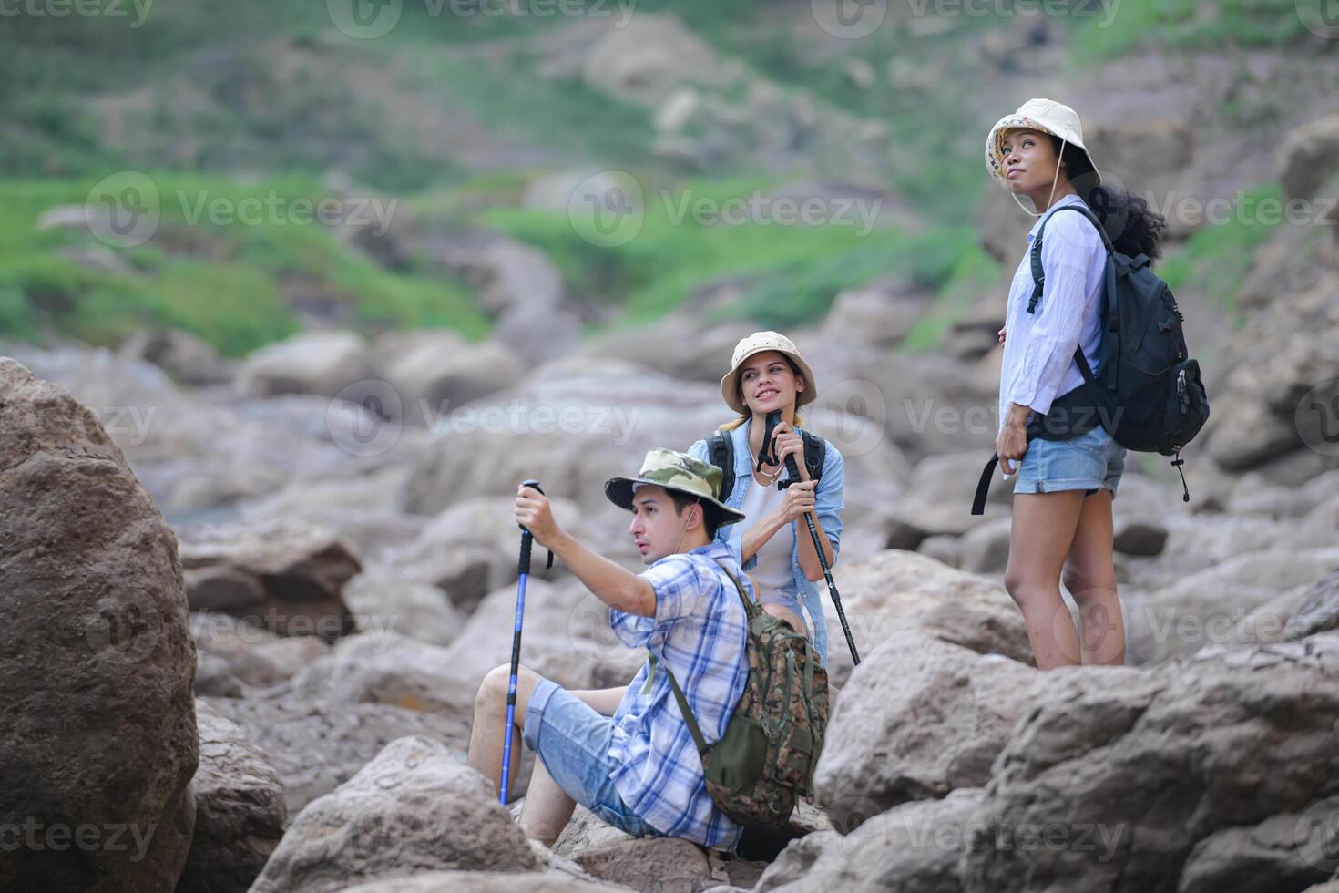 A group of friends going hiking in the streams of the tropical forest area. photo