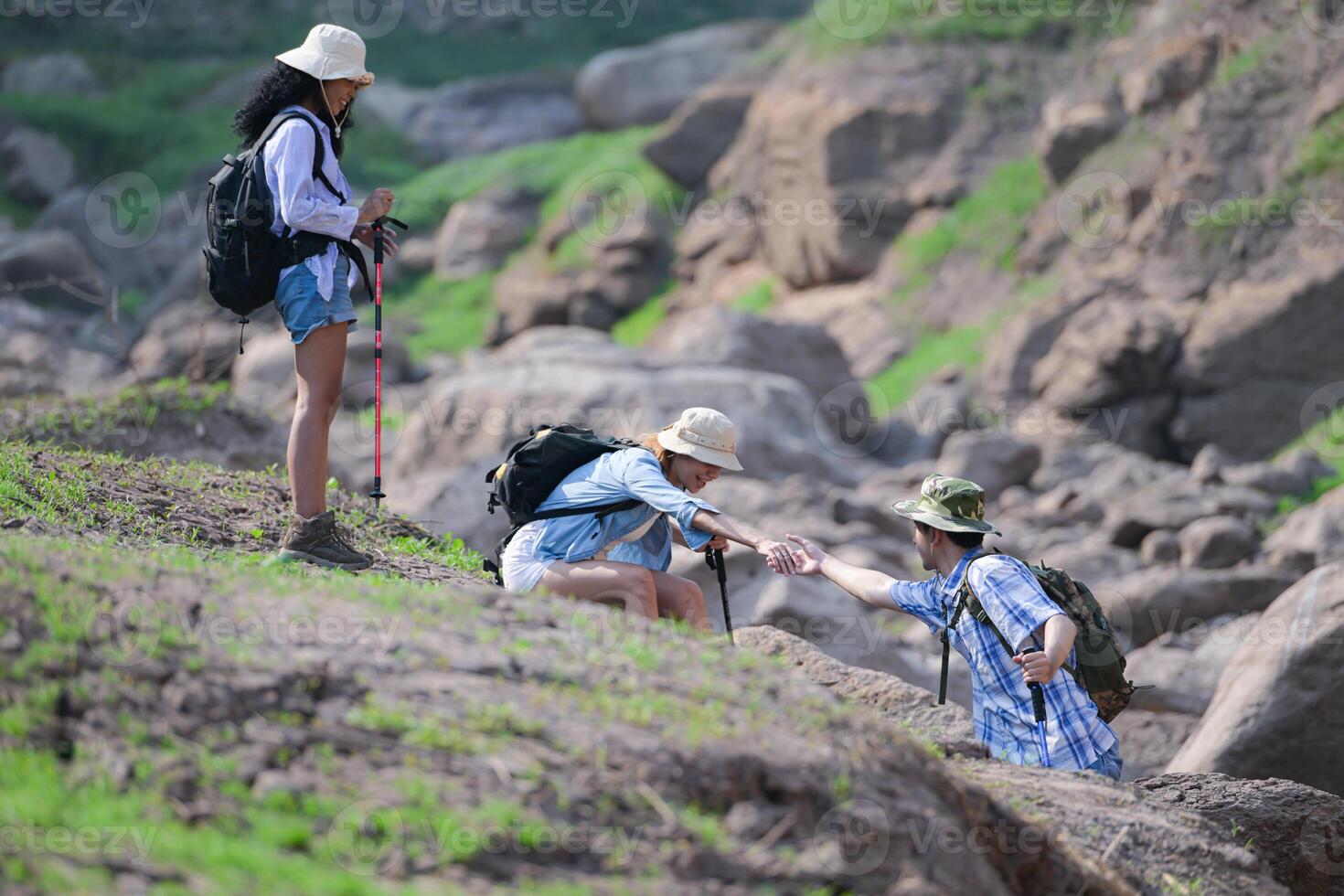 A group of friends going hiking in the streams of the tropical forest area. photo