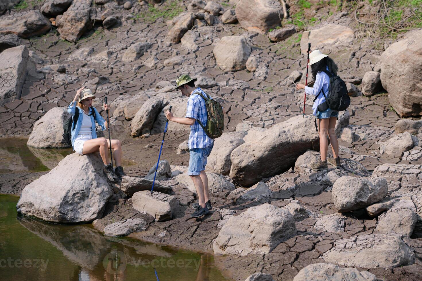 A group of friends going hiking in the streams of the tropical forest area. photo