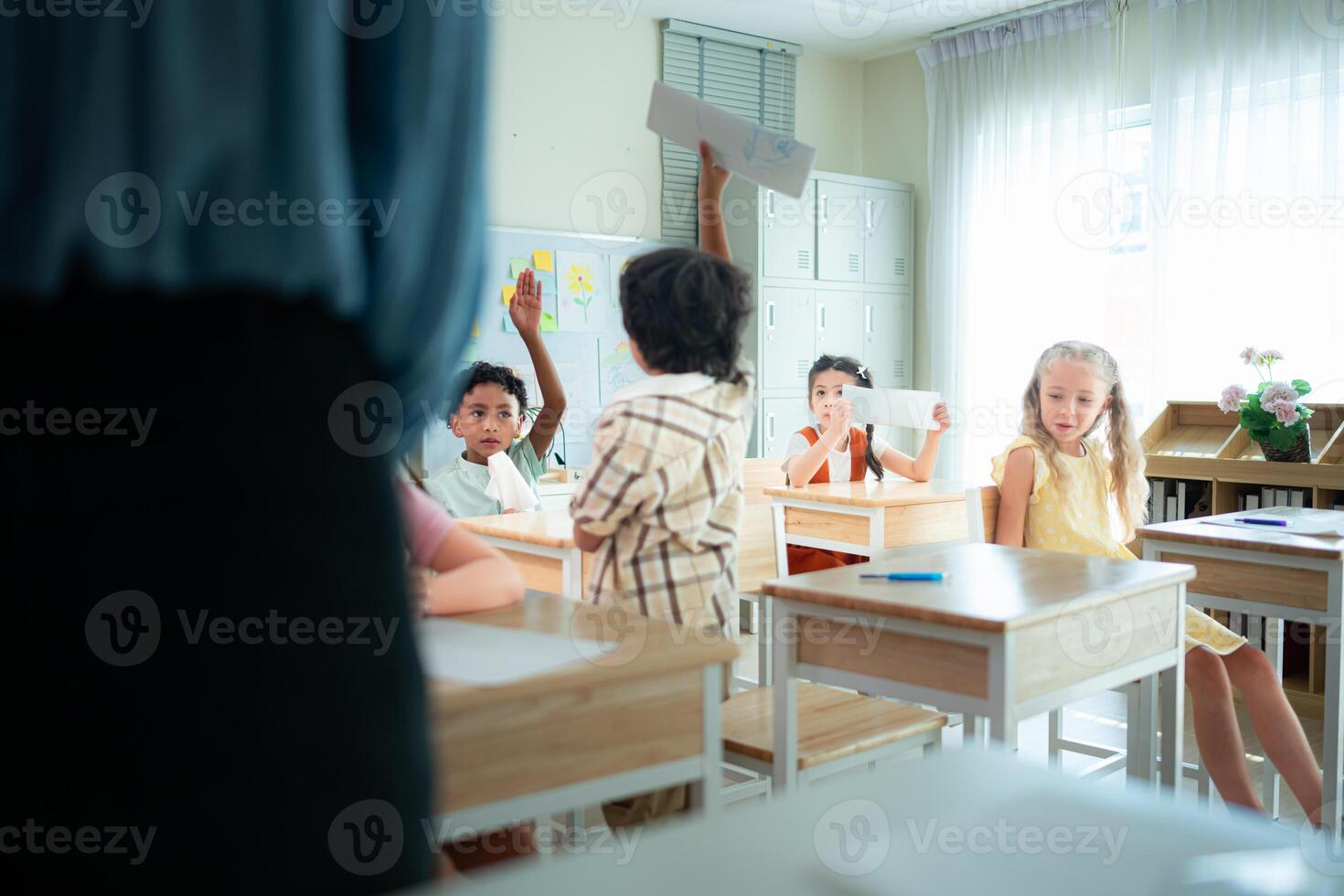 Teacher and students, Learn and study in a classroom of school where youngsters sit and listen attentively. photo