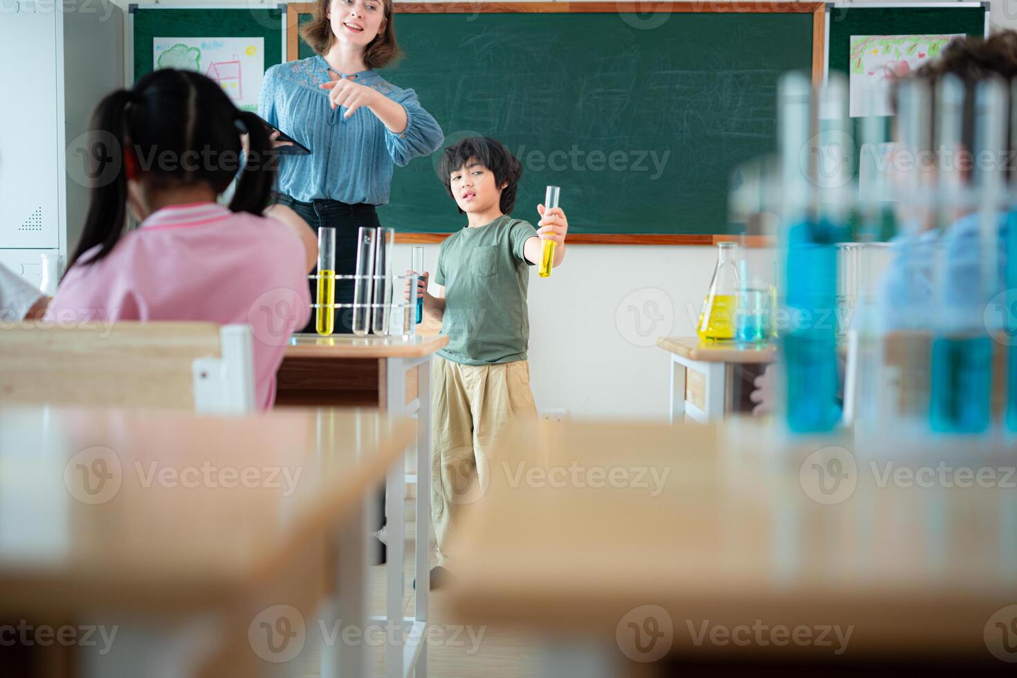 Teacher and students, Learn and experiment with science in a school science classroom. photo