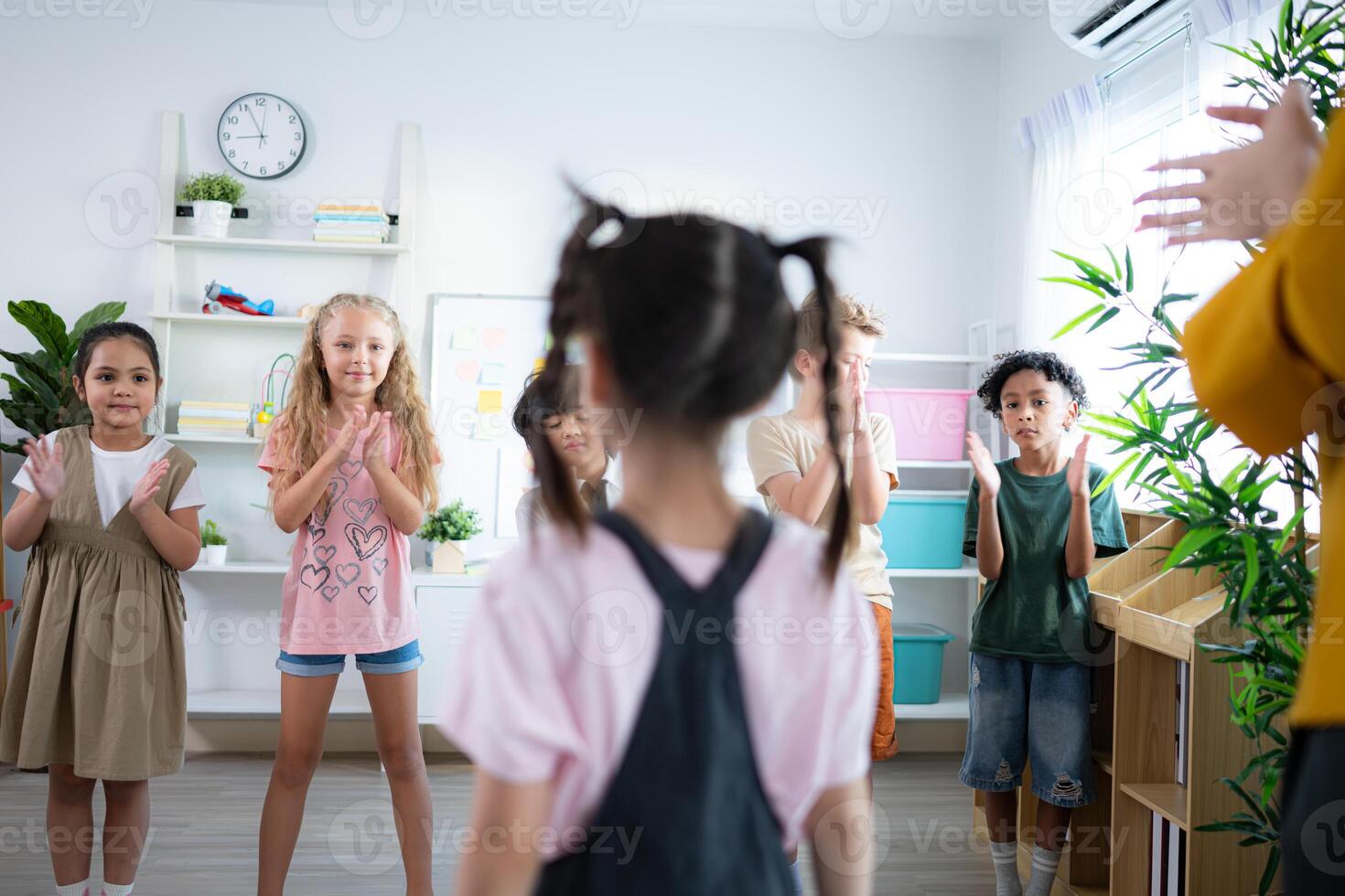 Teacher and students, Standing applause to congratulate one student in the class. photo