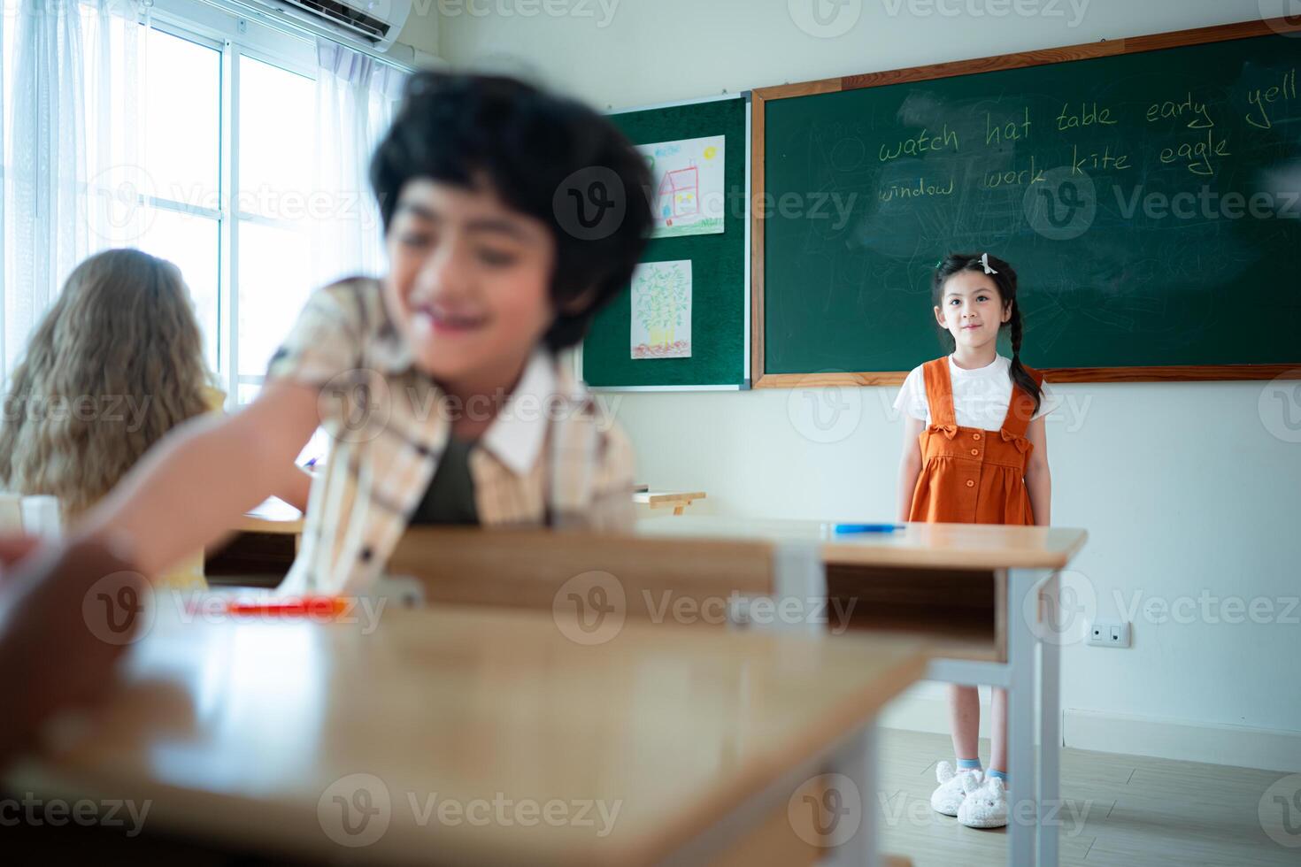 Children with classroom presentation activities in front of the classroom photo