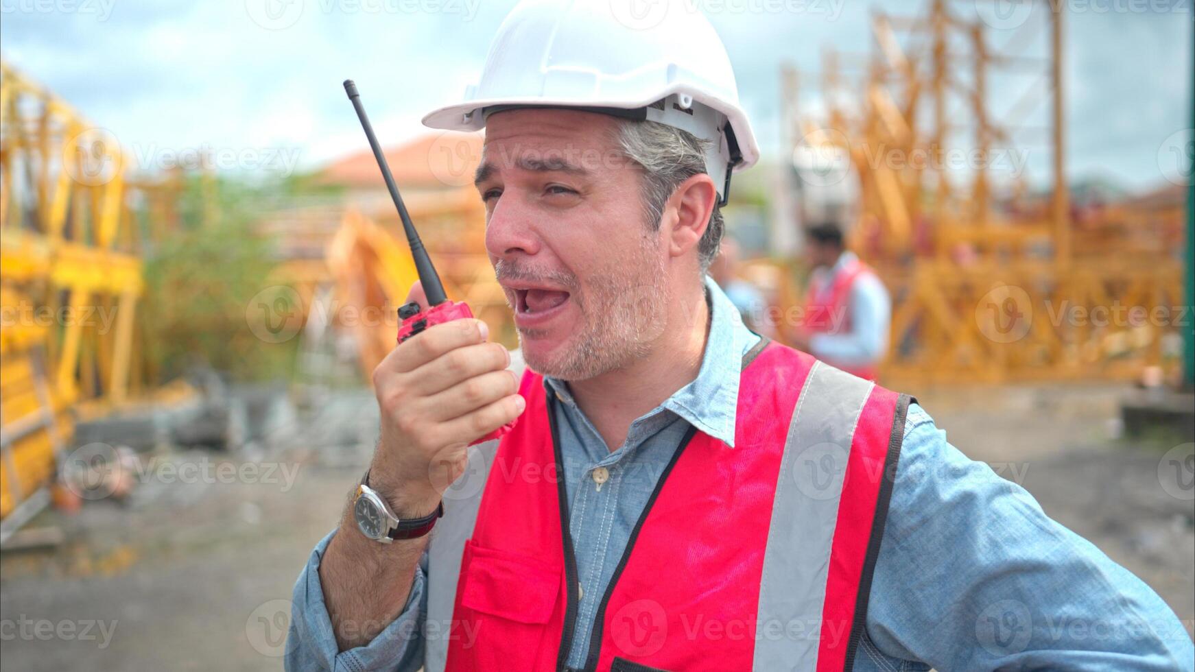 Portrait of crane worker on construction crane use walkie talkie to talk for made to transport the crane from storage to be assembled on the building construction site photo