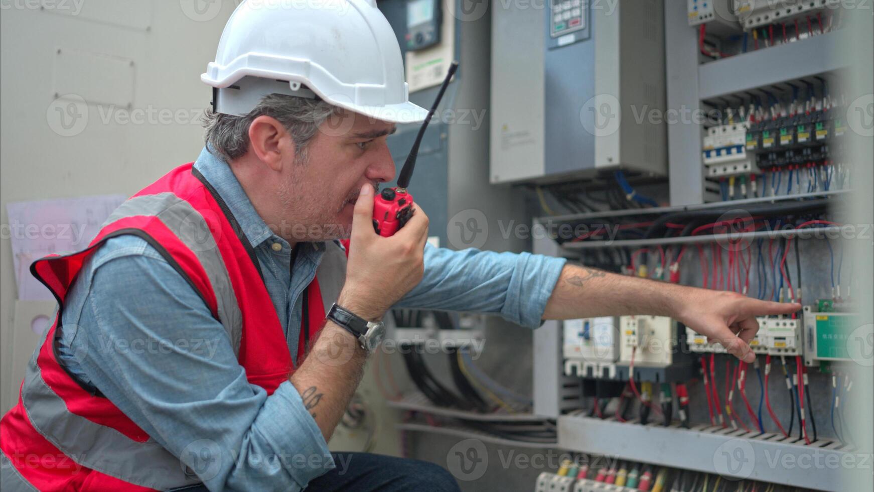 Electrical engineer inspects the electrical control board of a crane before putting it to use on a construction site photo