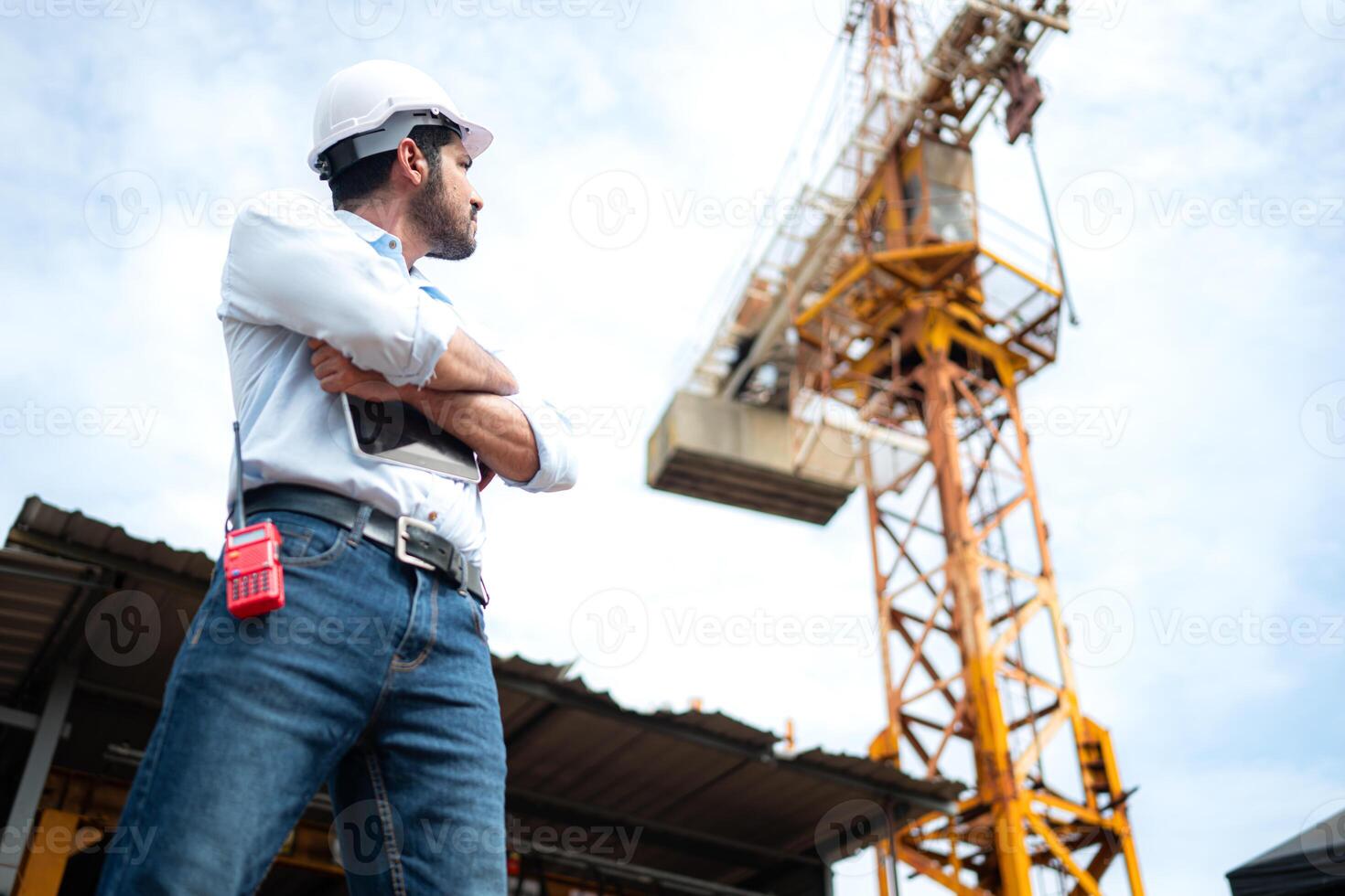 Portrait of engineer with tower crane for lift and move objects on building construction sites photo