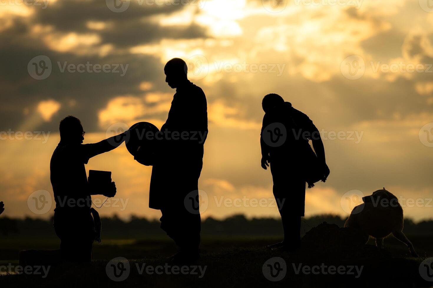 Monks with alms bowls walk out to take alms food from villagers early in the morning photo