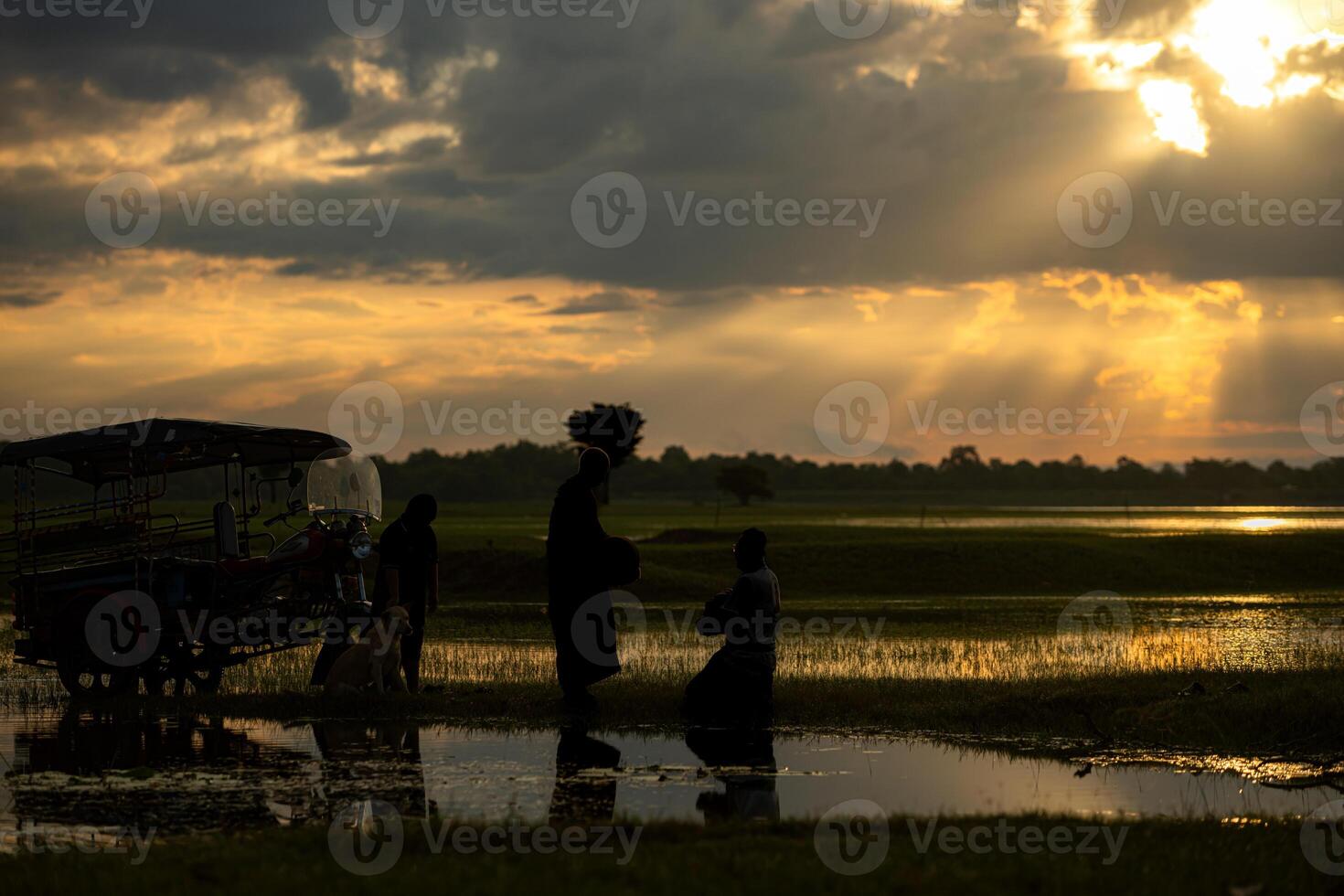 Monks with alms bowls walk out to take alms food from villagers early in the morning photo