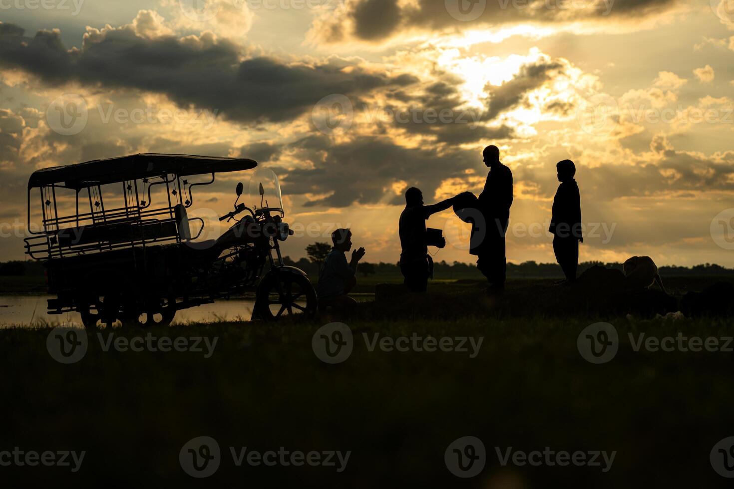 Monks with alms bowls walk out to take alms food from villagers early in the morning photo
