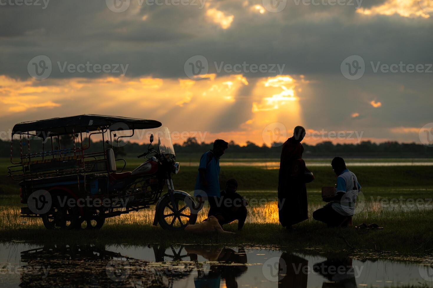 Monks with alms bowls walk out to take alms food from villagers early in the morning photo