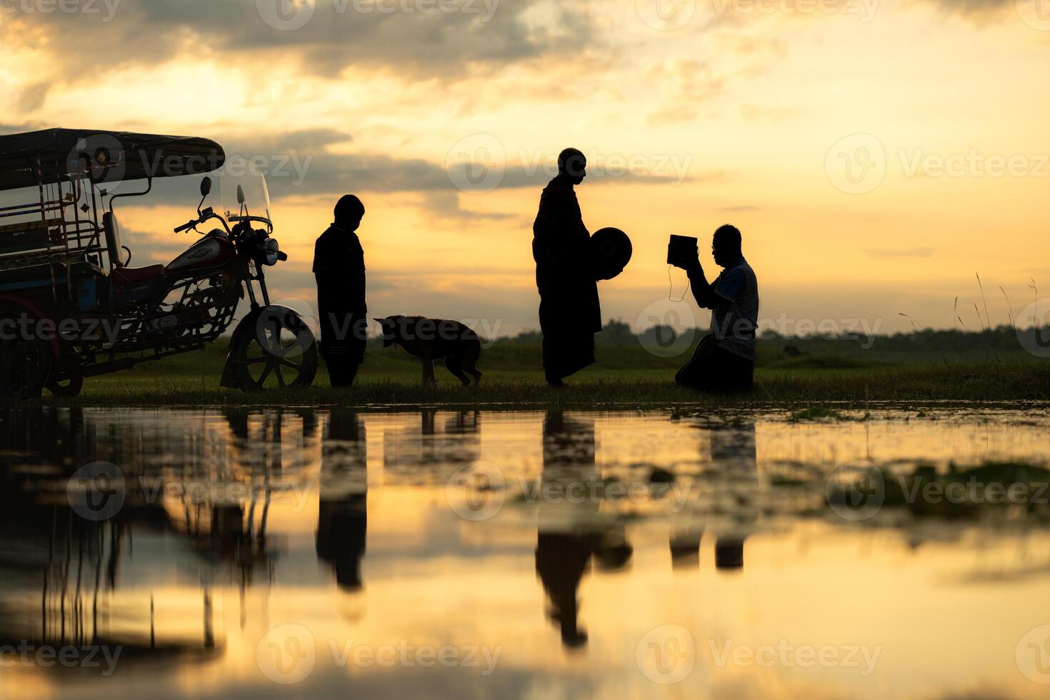 Monks with alms bowls walk out to take alms food from villagers early in the morning photo