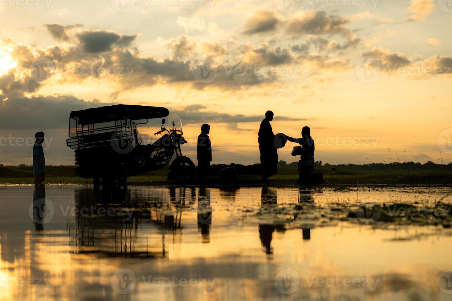 Monks with alms bowls walk out to take alms food from villagers early in the morning photo