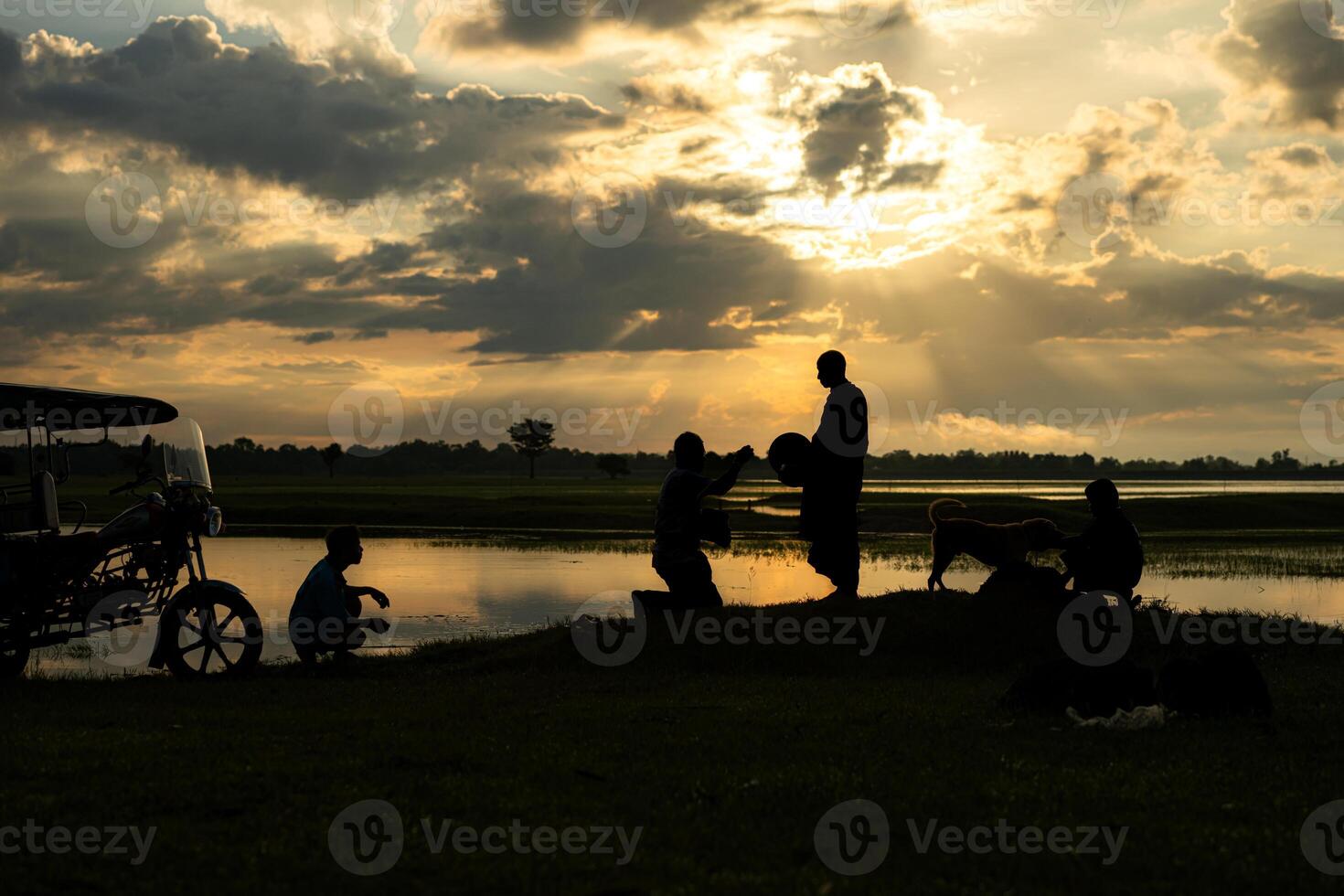Monks with alms bowls walk out to take alms food from villagers early in the morning photo