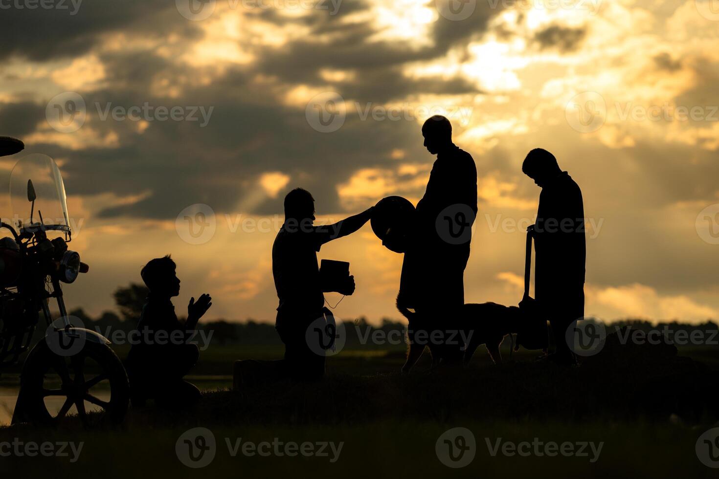 Monks with alms bowls walk out to take alms food from villagers early in the morning photo