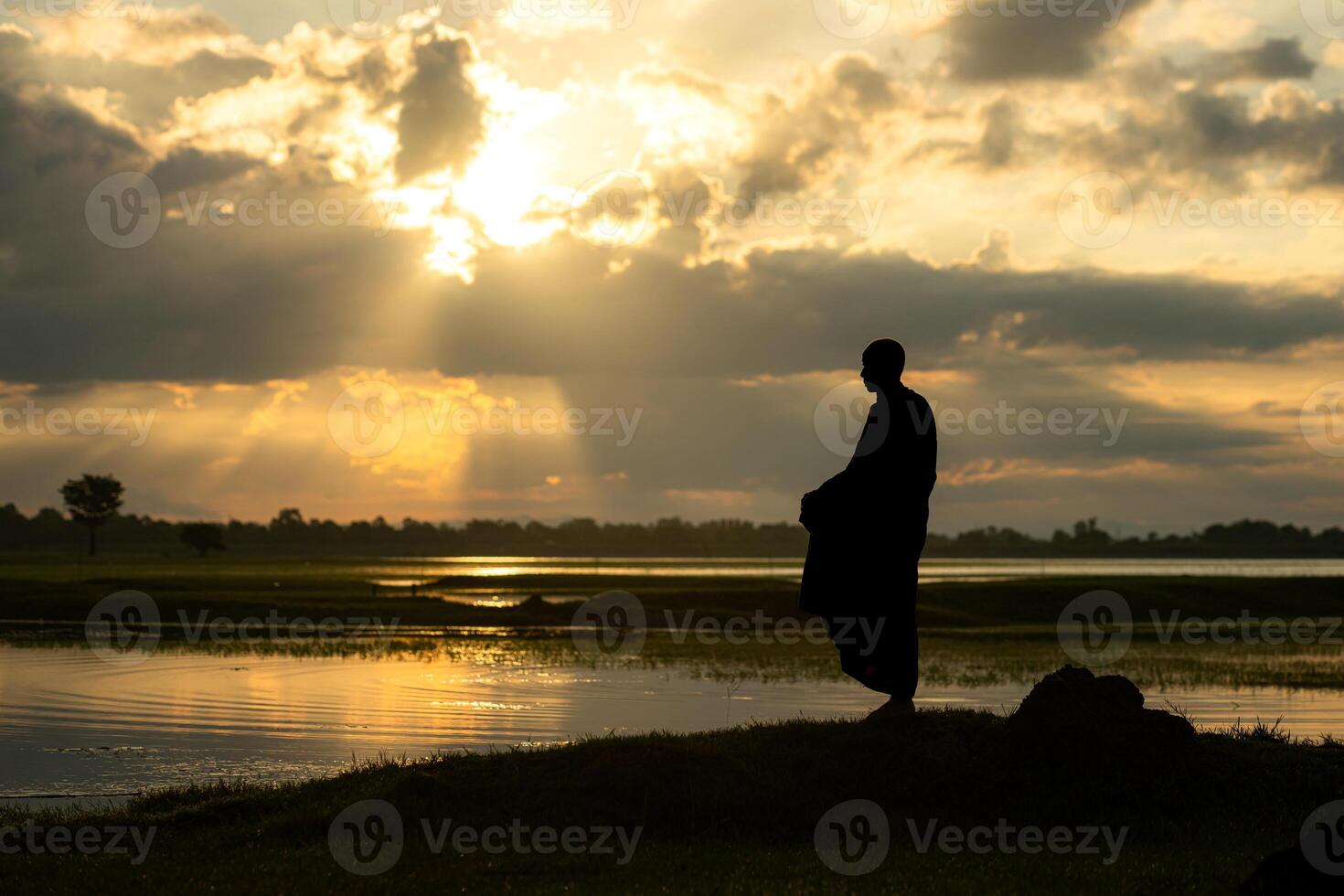 Monks with alms bowls walk out to take alms food from villagers early in the morning photo
