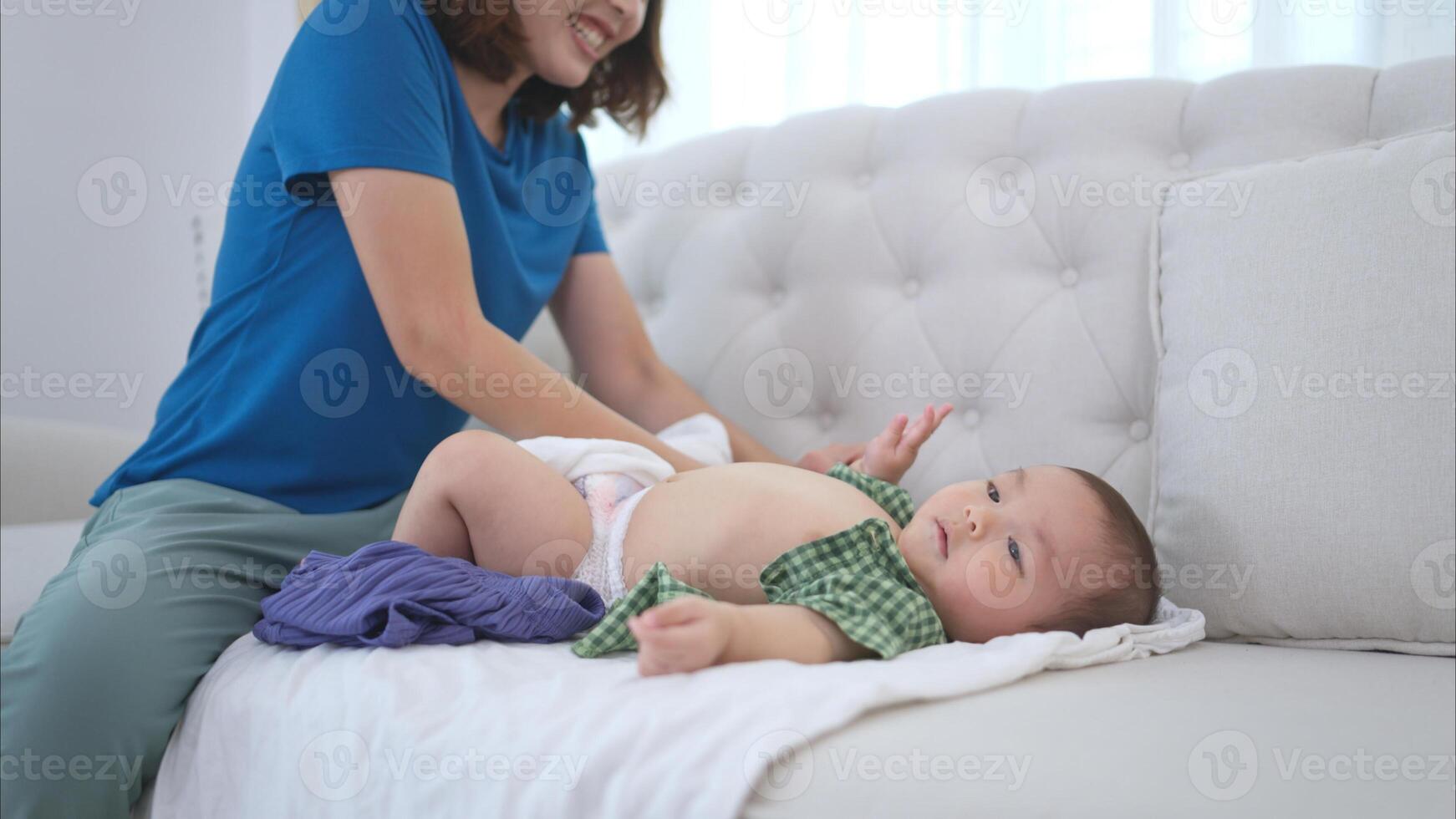 Parents help dress and dress their little child photo