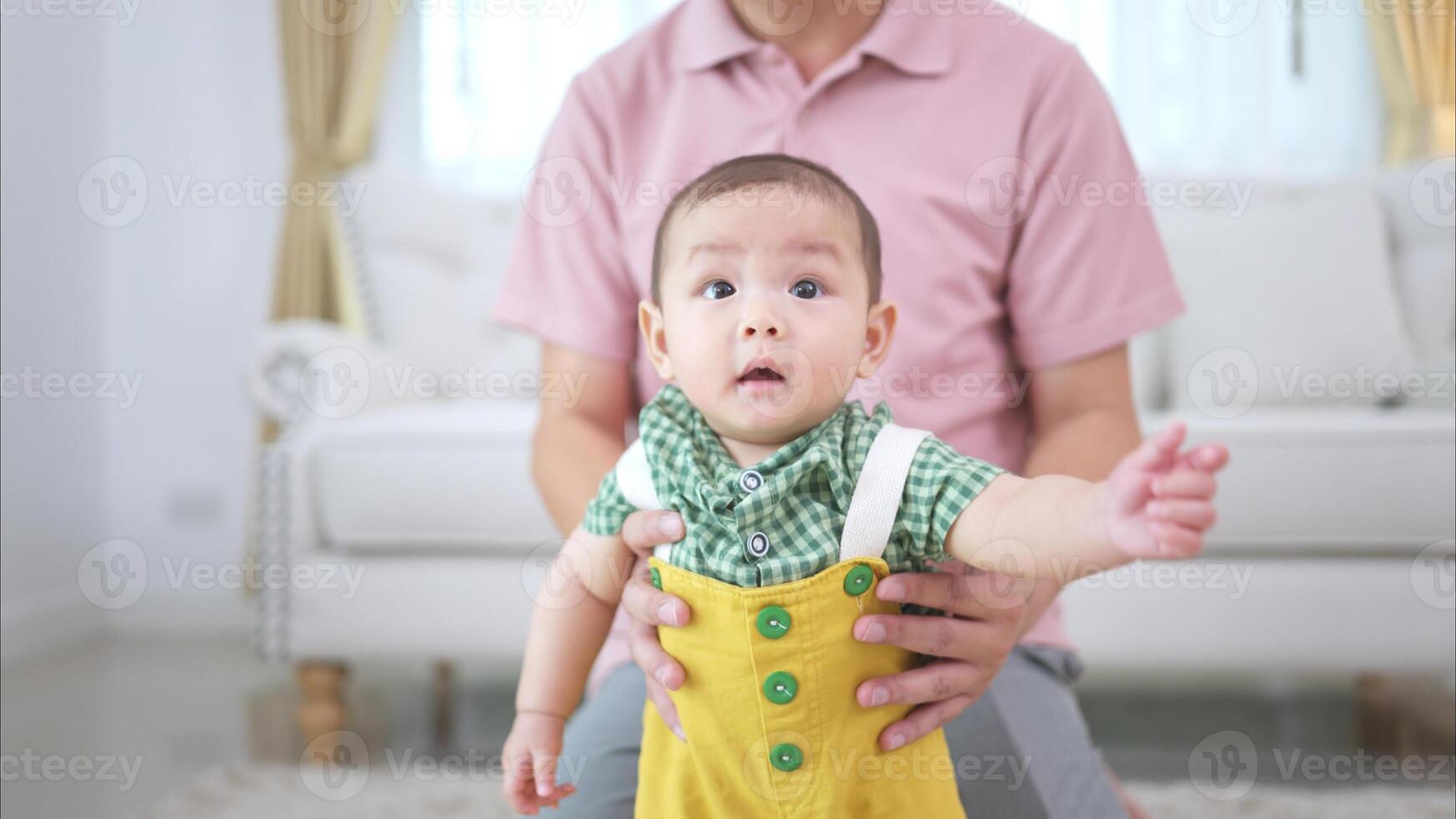 Father and their little child play happily in the living room of the house photo