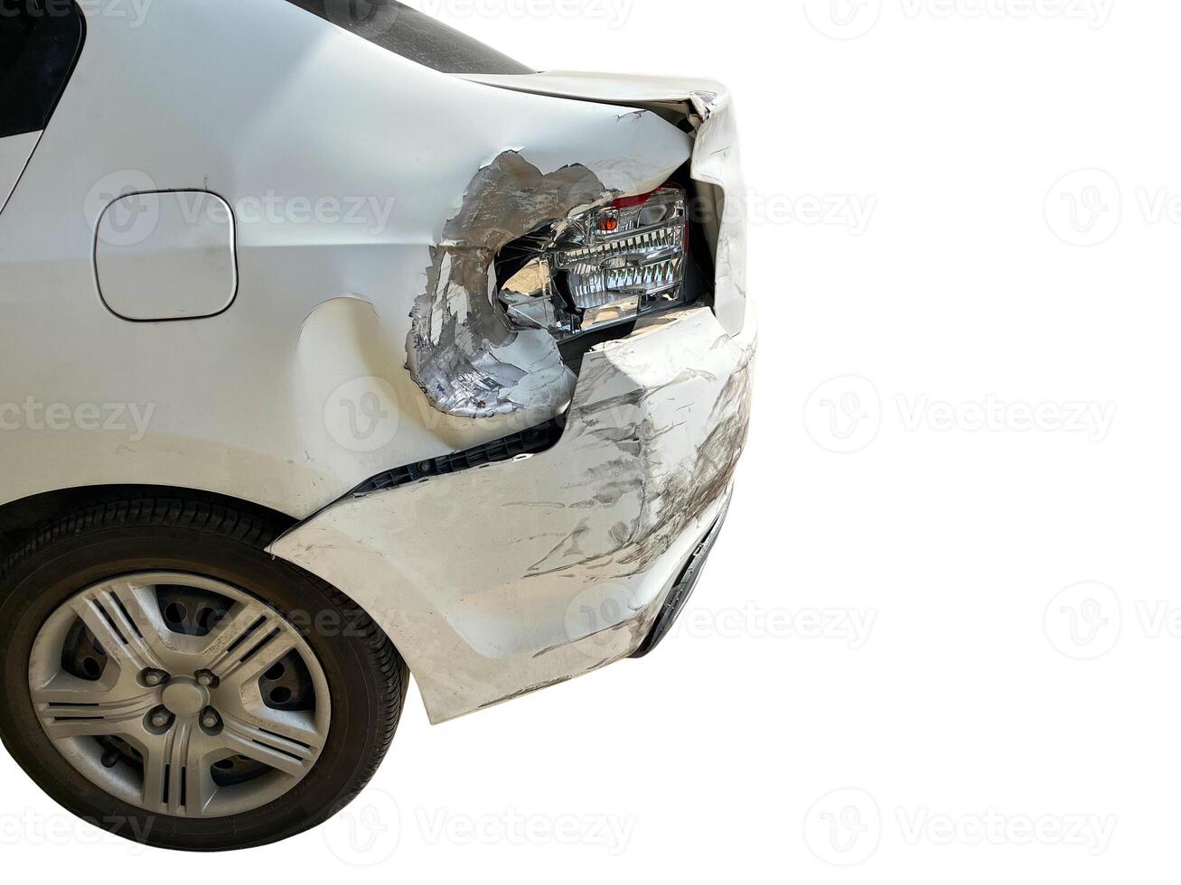 White car's rear end showing significant damage to the bumper and tail light isolated on white background with clipping path photo