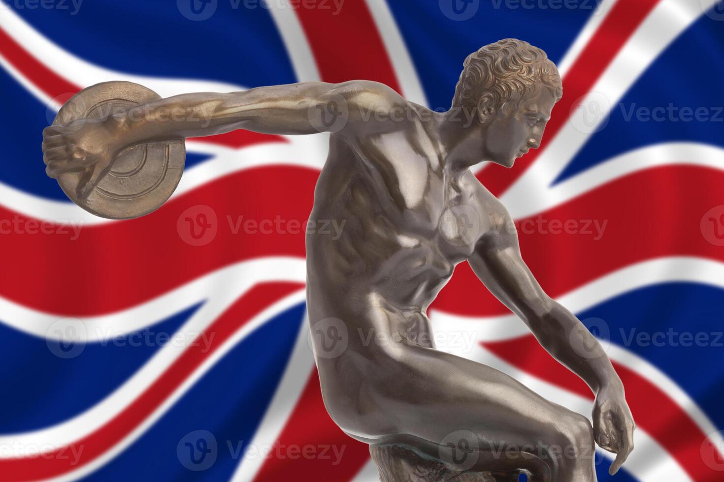 The olympic statue is in front of the british flag photo