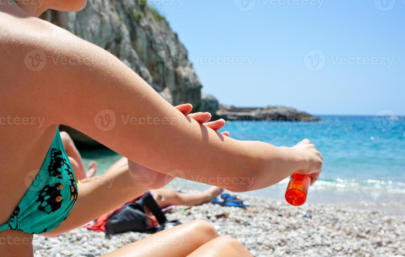 A woman sitting on the beach photo