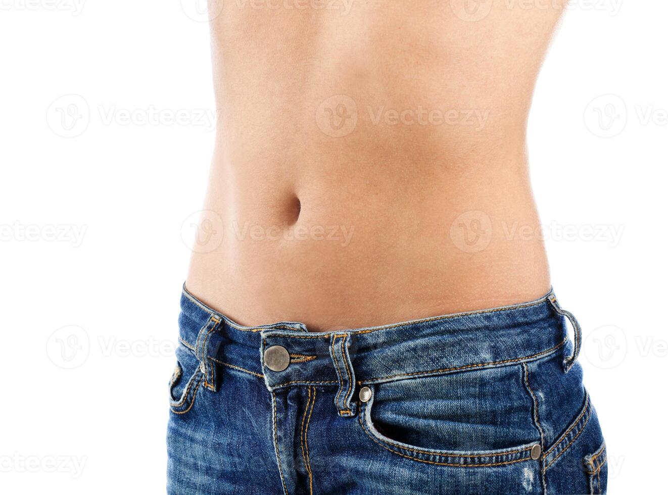 A woman's stomach with her jeans on photo