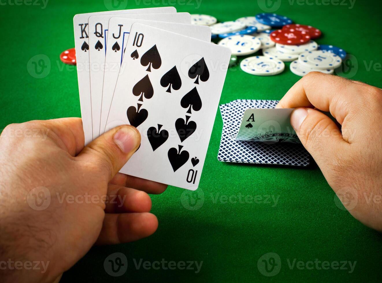 A person holding a pair of cards and playing cards photo