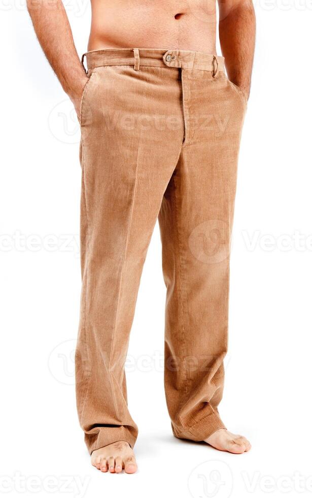 A man with no shirt and tan pants photo
