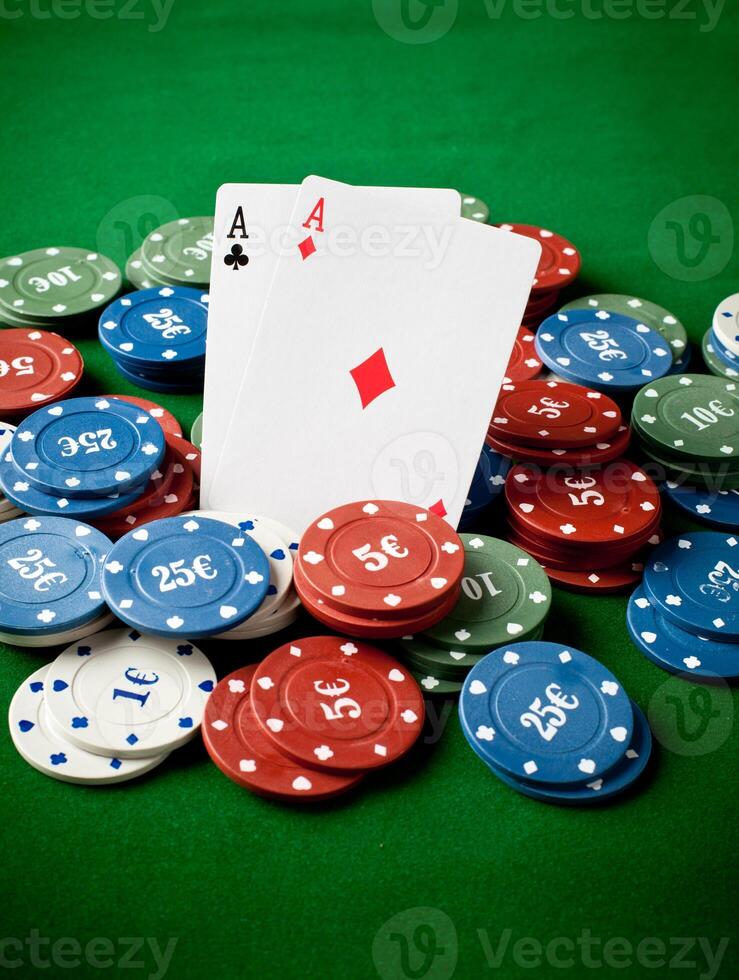 A pair of aces and a pair of aces are sitting on top of a pile of photo