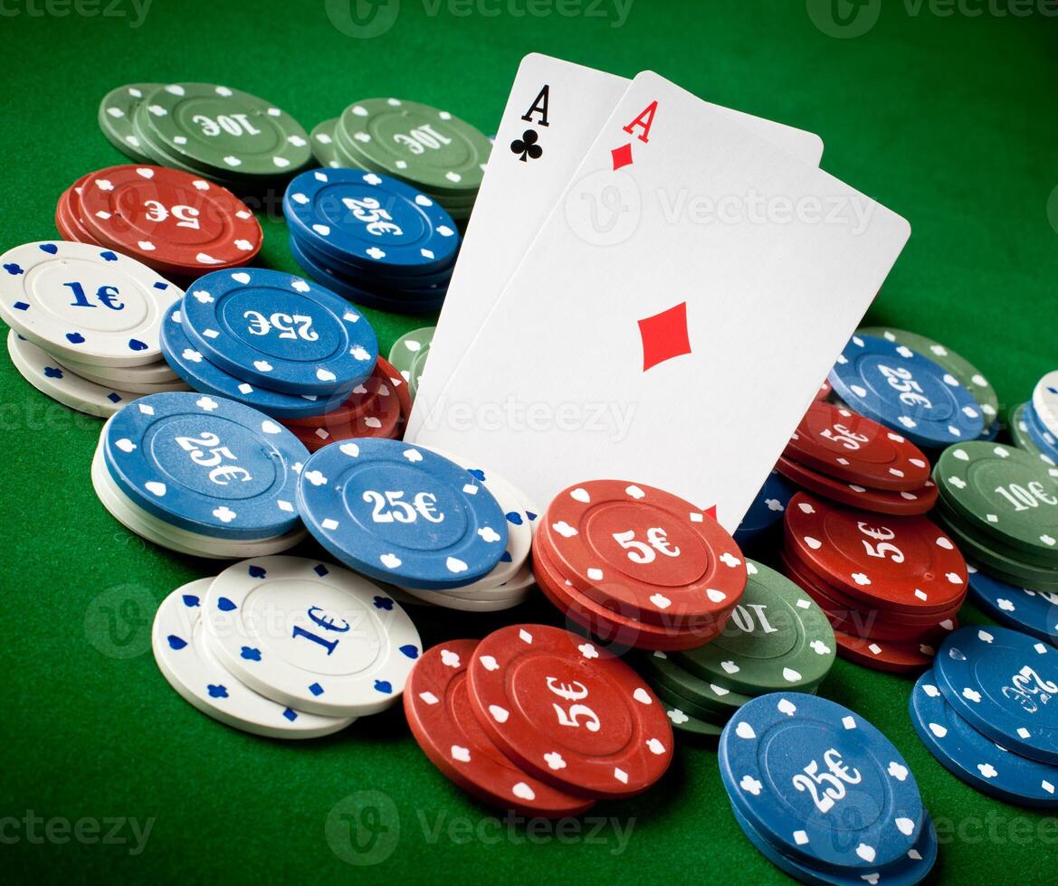 A pair of aces and a pair of aces are sitting on top of a pile of photo
