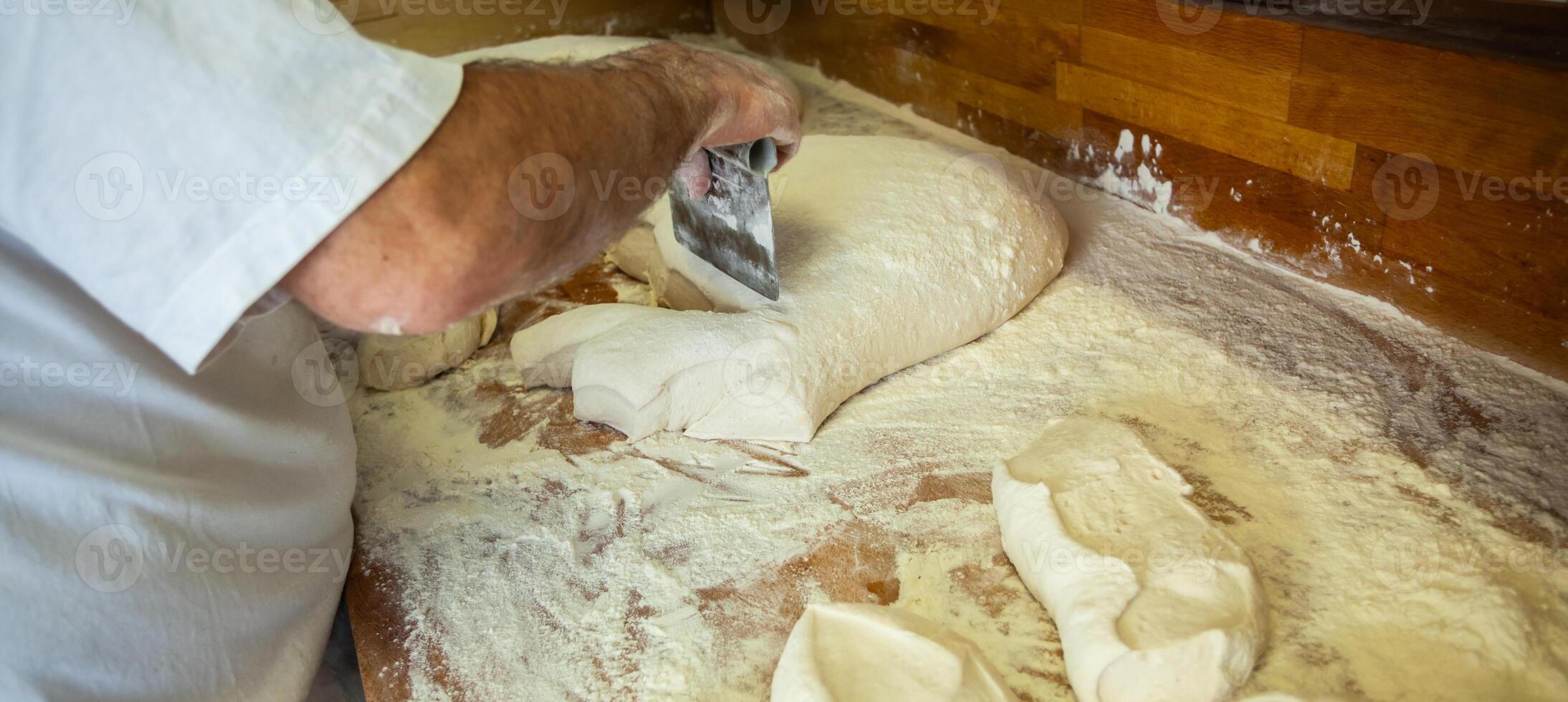 Production of baked bread with a wood oven in a bakery. photo