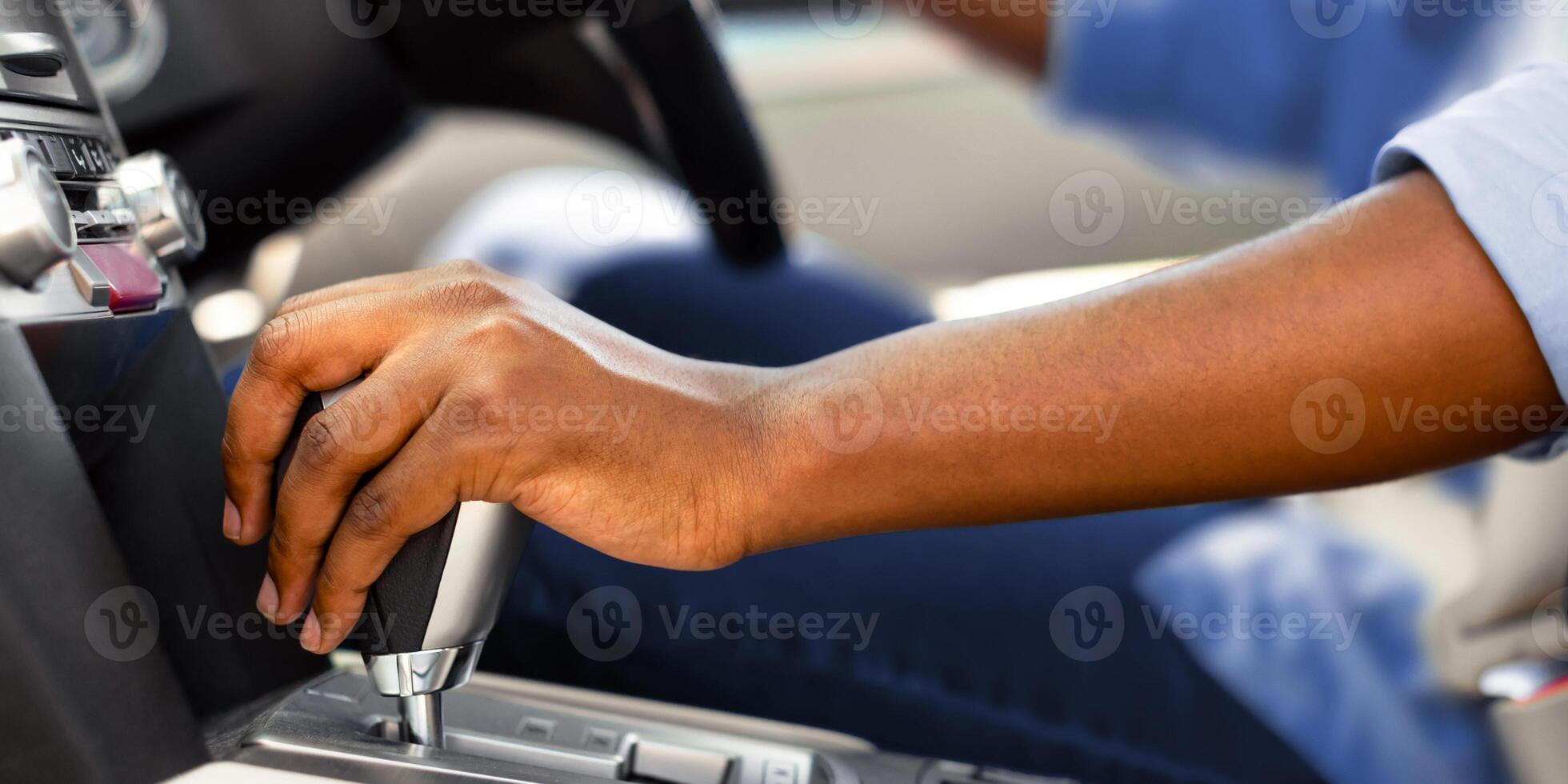 Car Driving Concept. Unrecognizable African American Male Driver Shifting To Drive Mode. Closeup Of Hand on Transmission Stick, Selective Focus. Riding Automobile photo