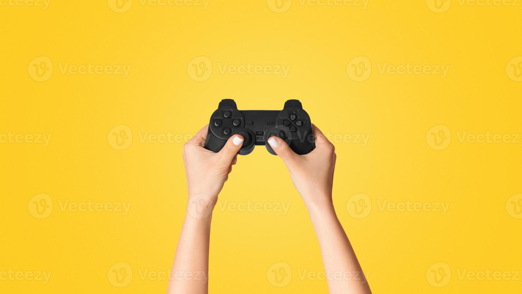 Fun hobbies concept. Woman holding game joystick on pink background, closeup. Panorama photo