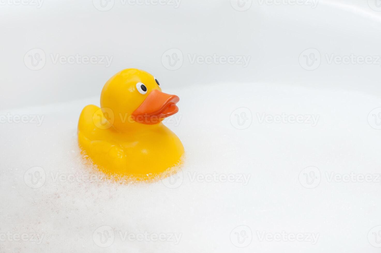 Rubber duck in foam bath photo