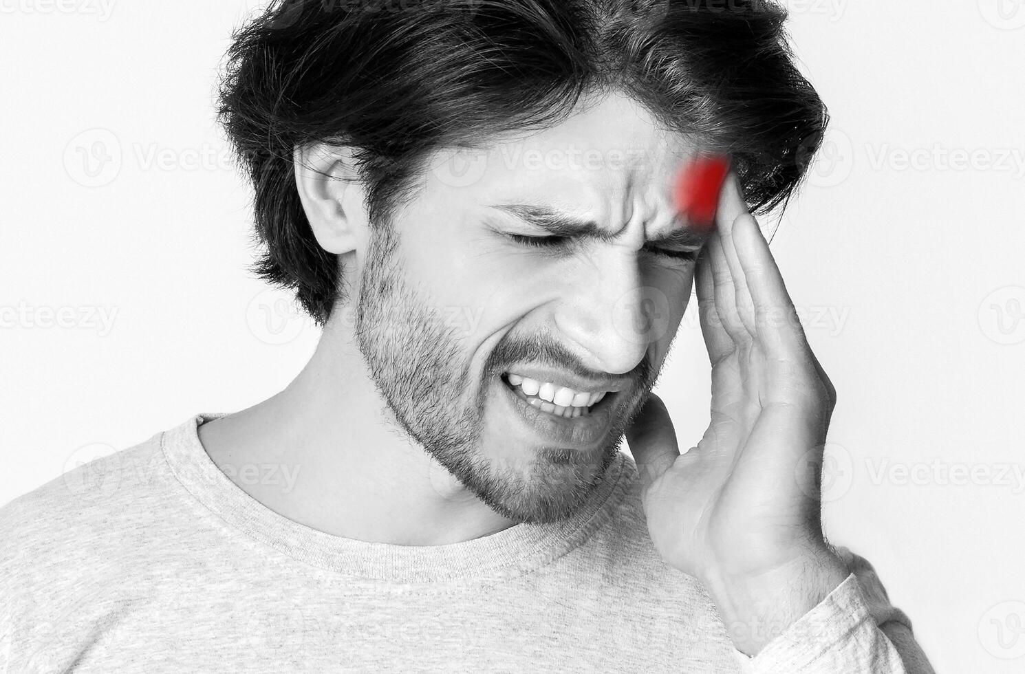 Headache, nervous tension and throbbing pain. Portrait of man massaging his temple, closes eyes photo