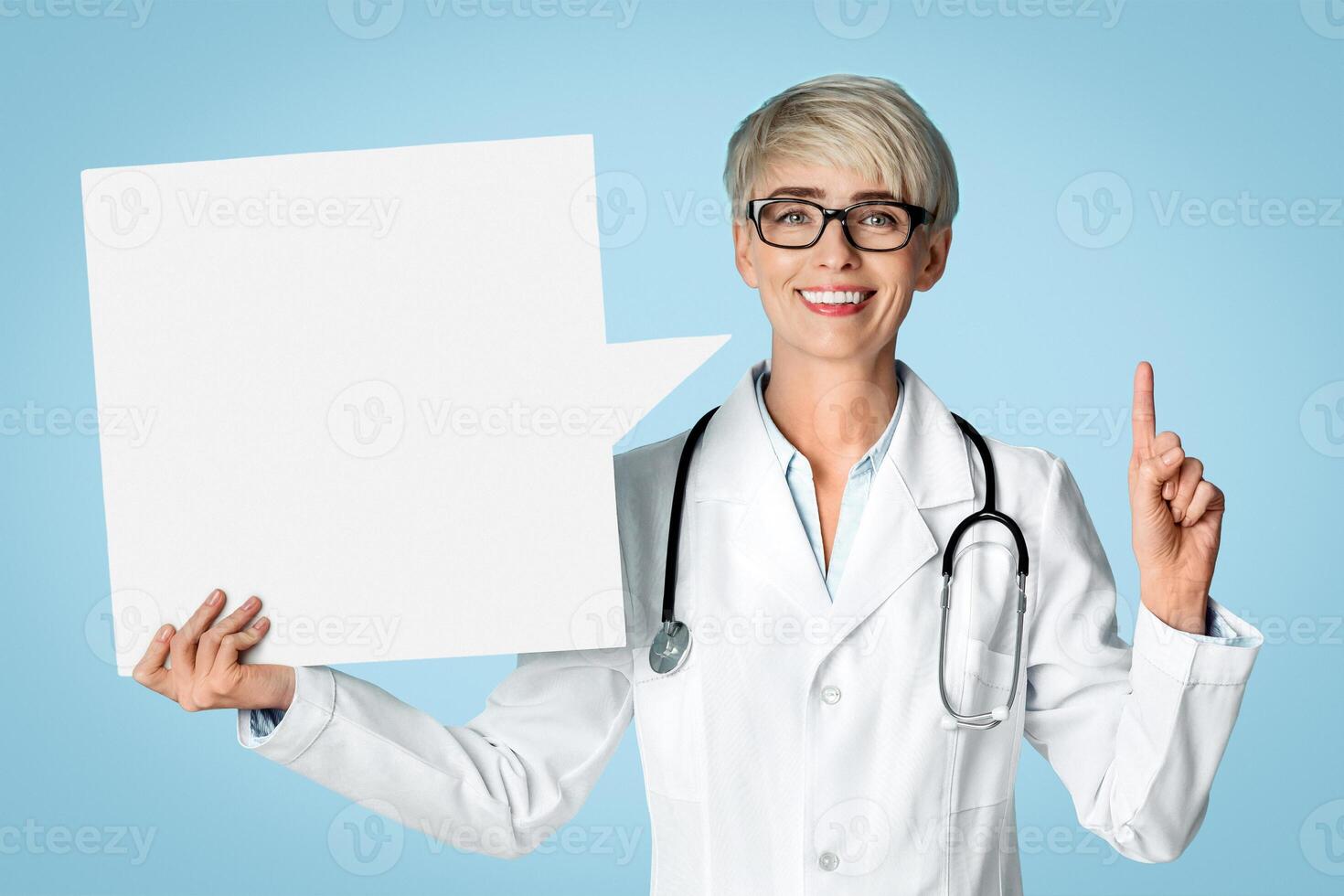 Doctor got an idea, points finger up and holds abstract place for words. On blue background photo