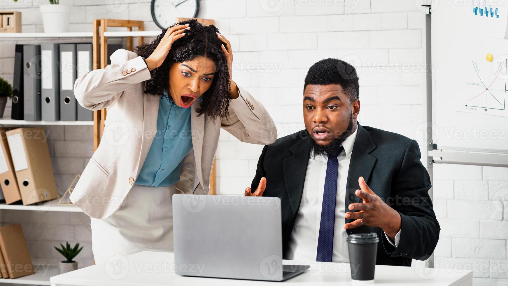 Nervous African American colleagues finding mistake in project or missing deadline at workplace photo