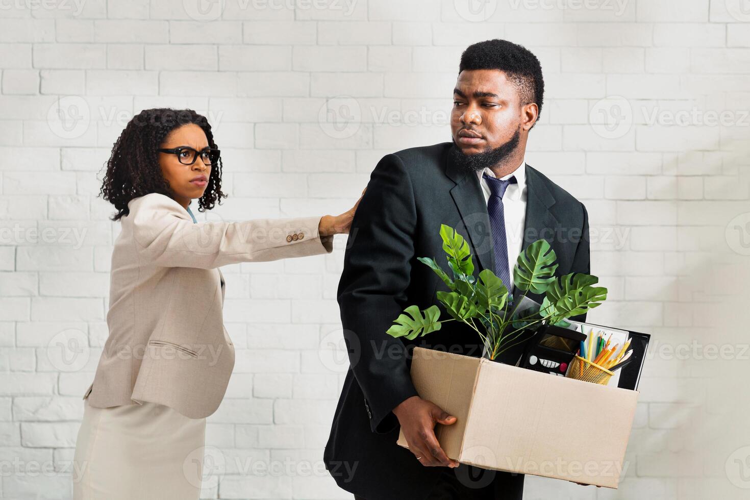 Job loss and unemployment concept. Female boss firing African American employee in office photo