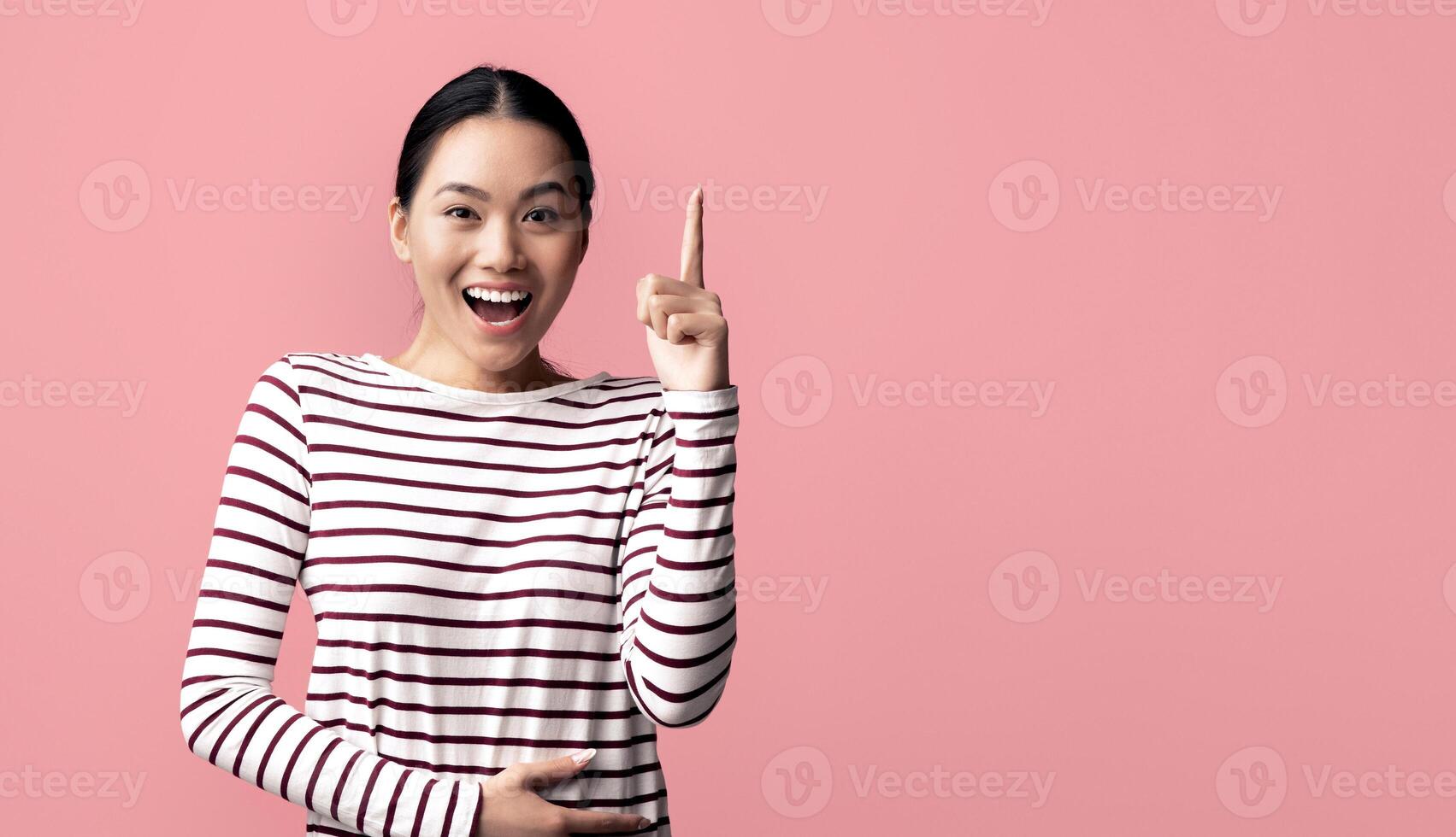 Excited Young Asian Woman Raising Finger Up, Having Good Idea, Cheerful Inspired Millennial Korean Female Found Solution To Problem, Standing Over Pink Background And Looking At Camera, Copy Space photo