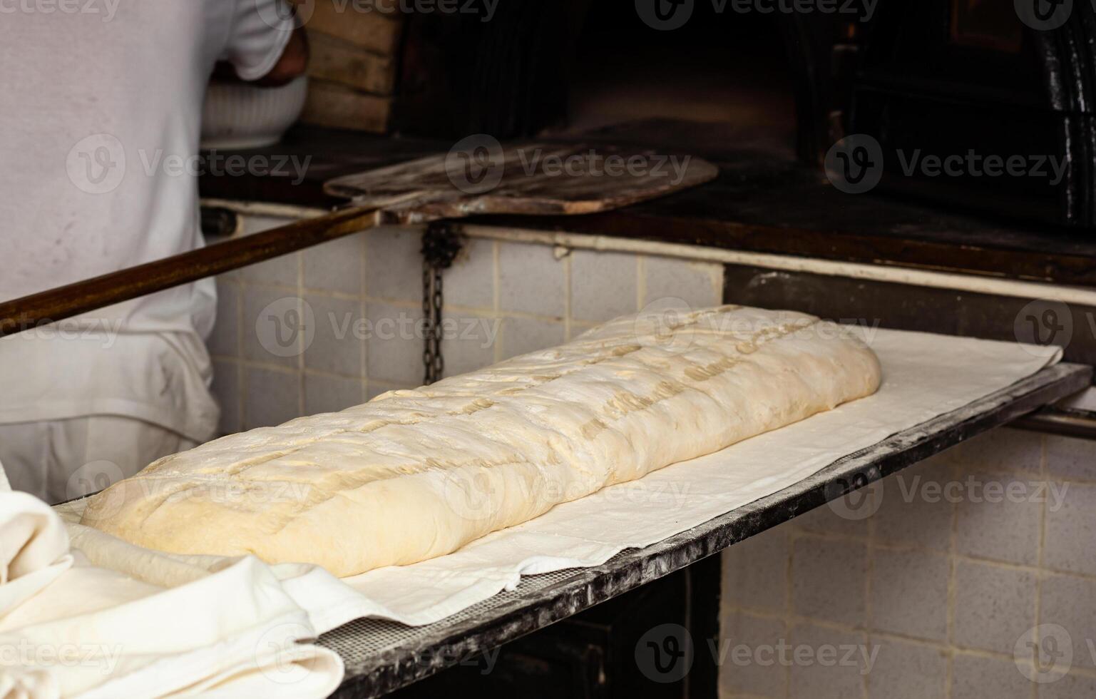 Production of baked bread with a wood oven in a bakery. photo