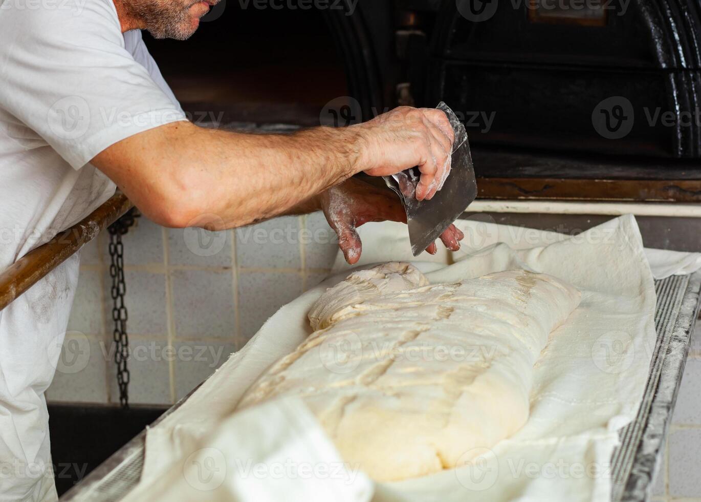 Production of baked bread with a wood oven in a bakery. photo
