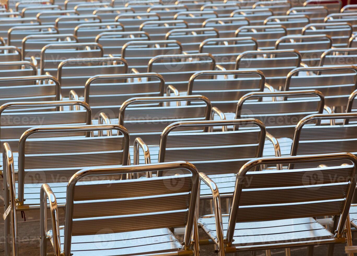 Empty metal seats places in public space photo