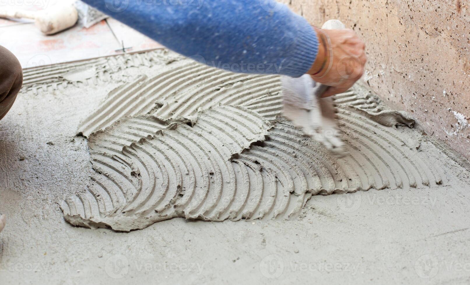 Tiler works with flooring. photo