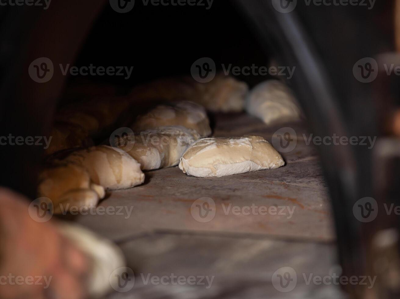 Production of baked bread with a wood oven in a bakery. photo