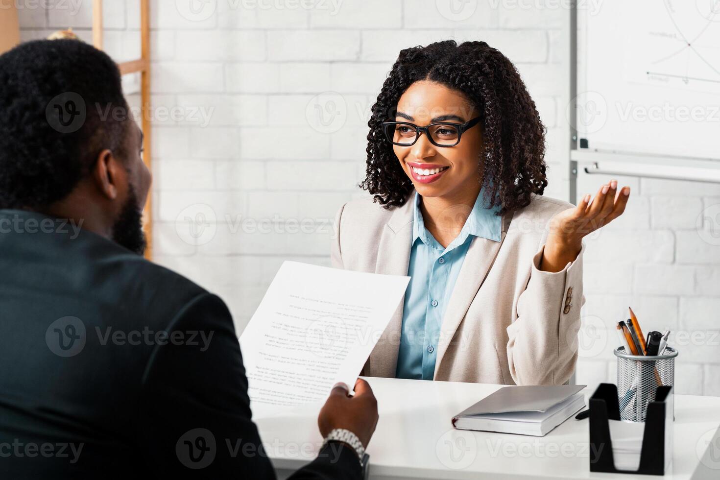 Friendly personnel manager interviewing black candidate during job interview at modern office, panorama photo
