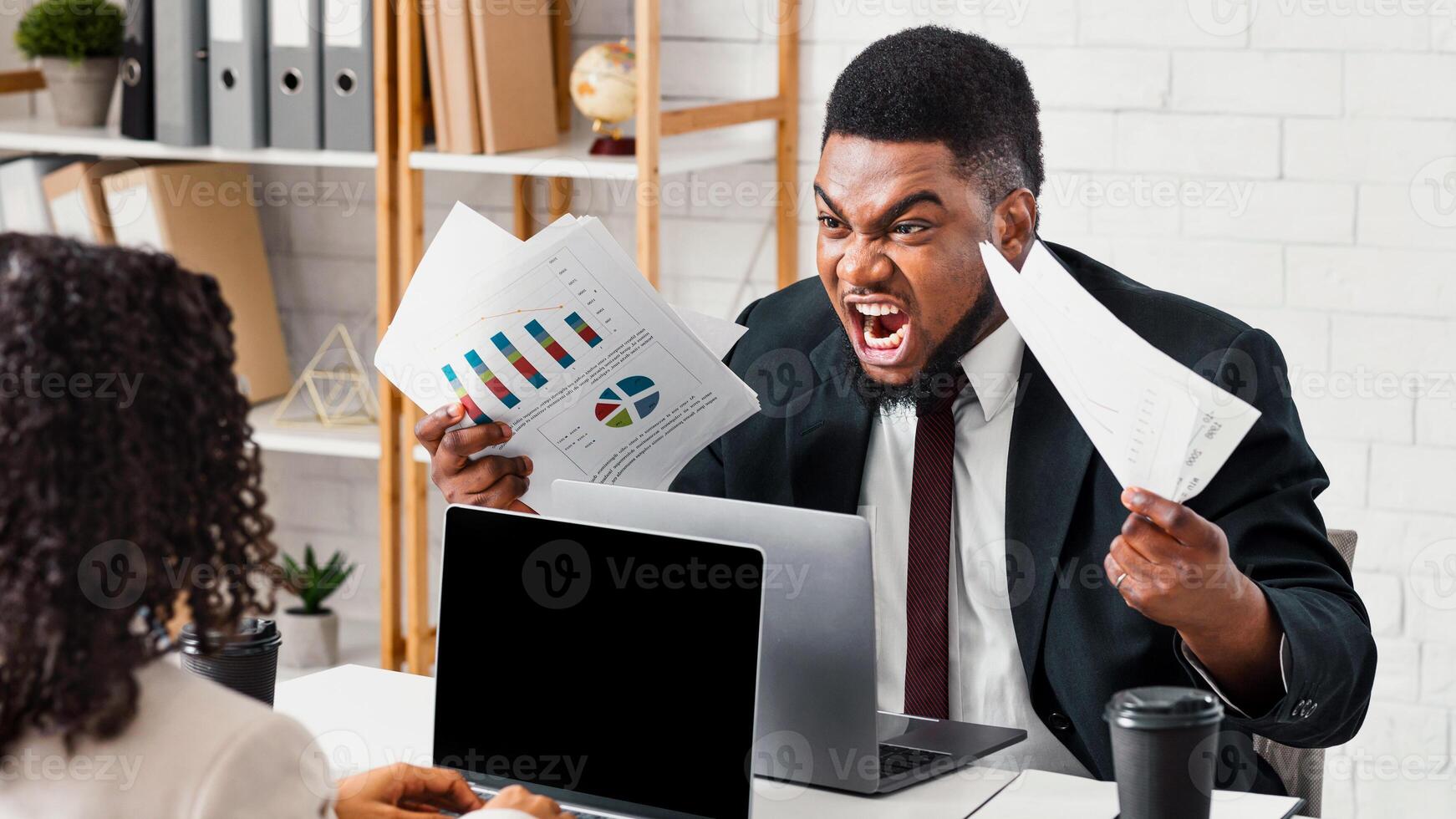 Furious black guy arguing with his female colleague at workplace, copy space photo